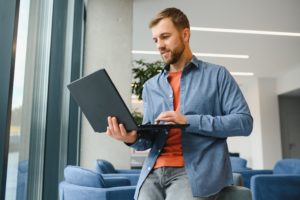 A Freelancer Man Works With A Laptop In A Work Coaching Office - Foguete GRX Contabilidade Digital